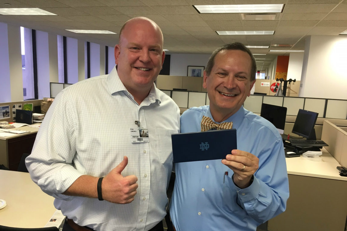Ryan LaMonica (1997) stopped by the CCSF office to give Mark Davis tickets to the Notre Dame/UGA football game!