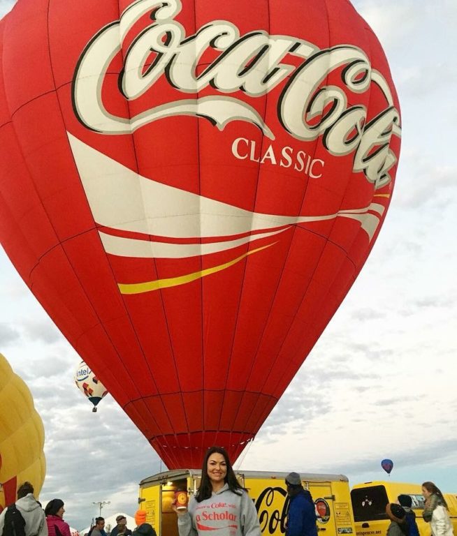 Erin Muffoletto (2003) sent us this photo with her wearing her Coke Scholars sweatshirt in front of the Coca-Cola balloon at the annual Hot Air Balloon Festival outside of Albuquerque, NM.