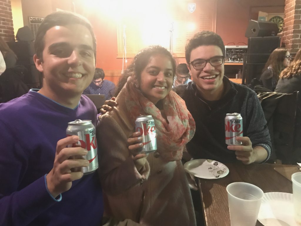 Deni Hoxha, Meena Venkataramanan, and Alec Fischthal formed a team to play some Harvard-Yale trivia during Harvard-Yale spirit week and decided to drink some Diet Coke, too. They love Coke as much as they love beating Yale!